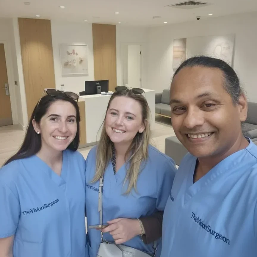 Mr Hatch Mukherjee with two colleagues in The Vision Surgeon scrubs in the clinic reception.