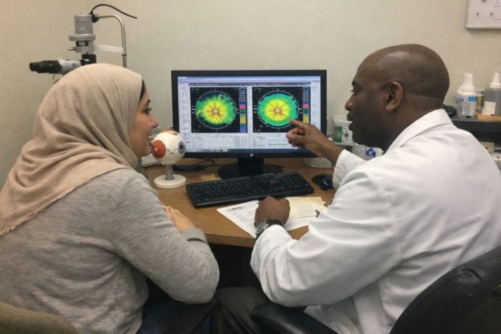An Illustrative image of a patient and eye surgeon both looking at corneal scans