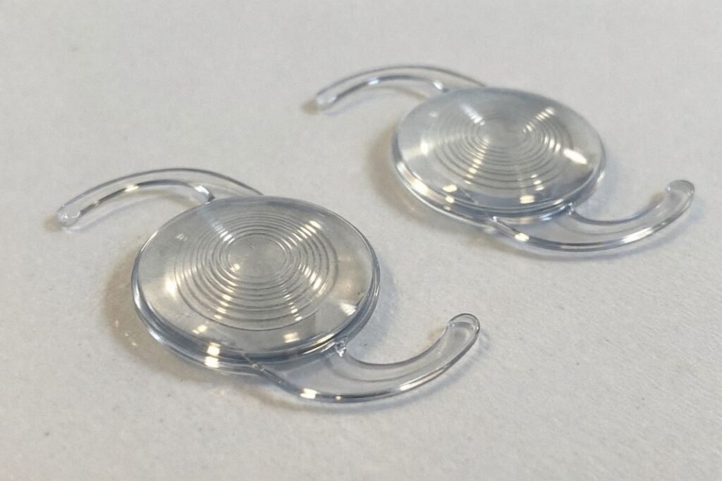 An illustrative image of a pair of multifocal intraocular lenses resting on a plain white background